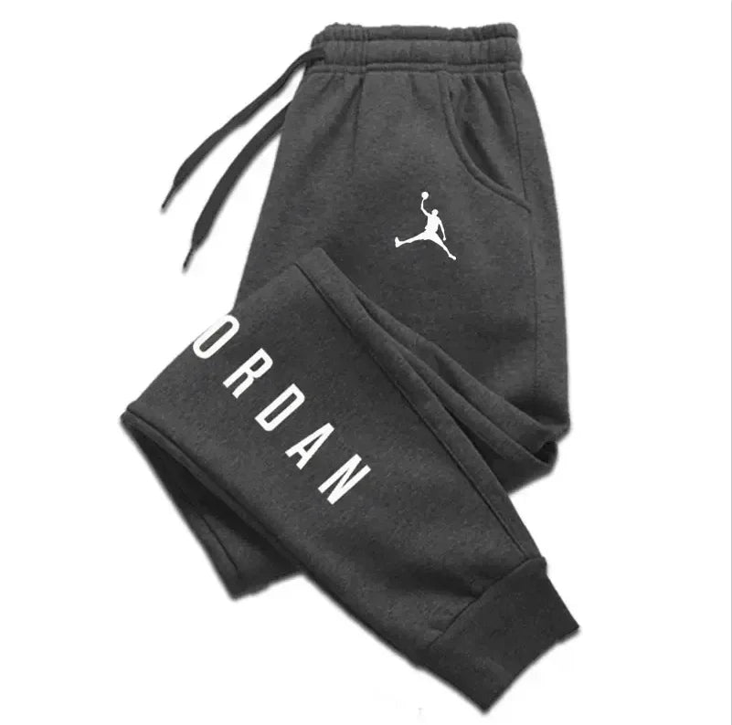 Men’s casual sweatpants in black with white Jordan logo and vertical branding, featuring a drawstring waist and side pockets for comfort and style.