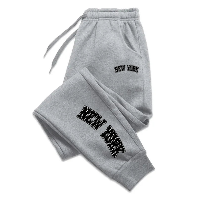 Men’s casual sweatpants in light gray with black logo print, featuring drawstring waist for comfort and sporty style.