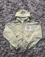 Noxwear Anime Hoodies in light green featuring zip‑up front, chest pockets with flap detail, and sleeve patch accent for oversized streetwear style.