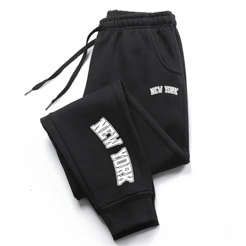 Men’s casual sweatpants in black with white logo print, featuring drawstring waist for comfort and sporty style.