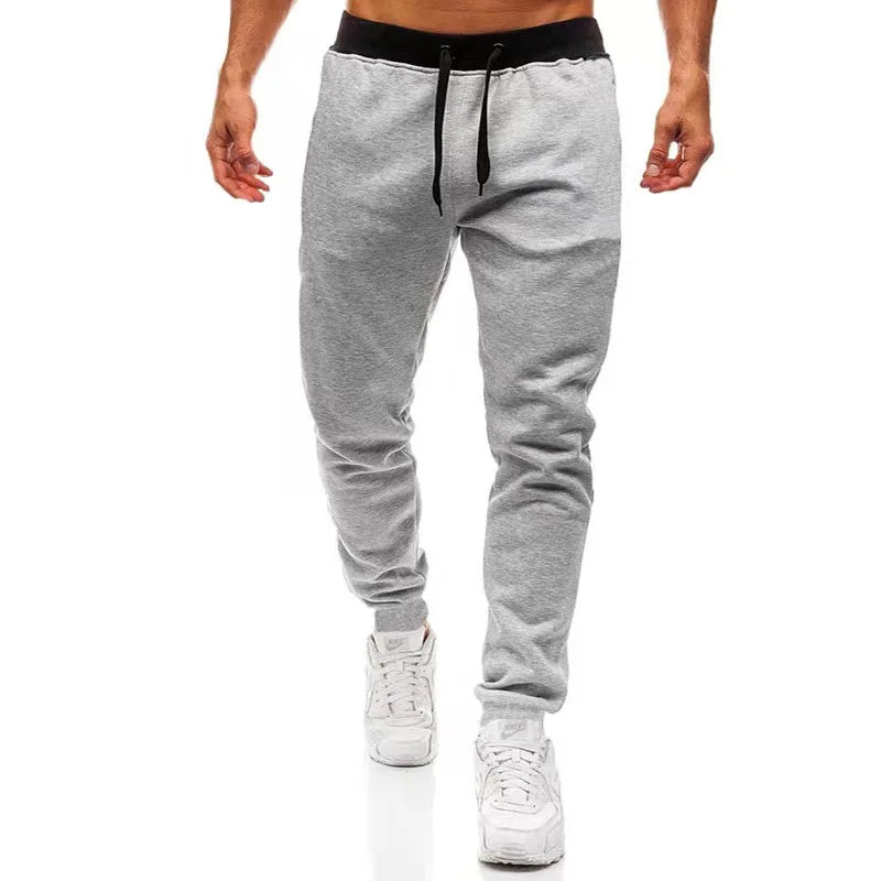 Men’s Sports Jogger Pants in gray, featuring an athletic fit and modern style, ideal for workouts and casual outings.
