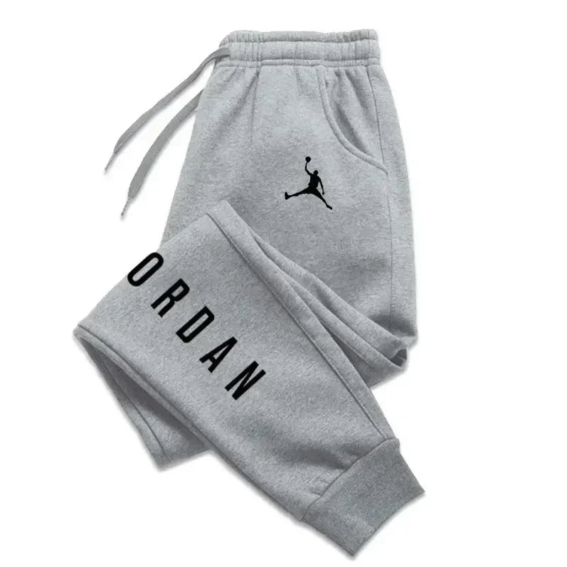 Men’s casual sweatpants in light gray with bold black Puma logo and vertical branding, featuring drawstring waist for comfort and sporty style.