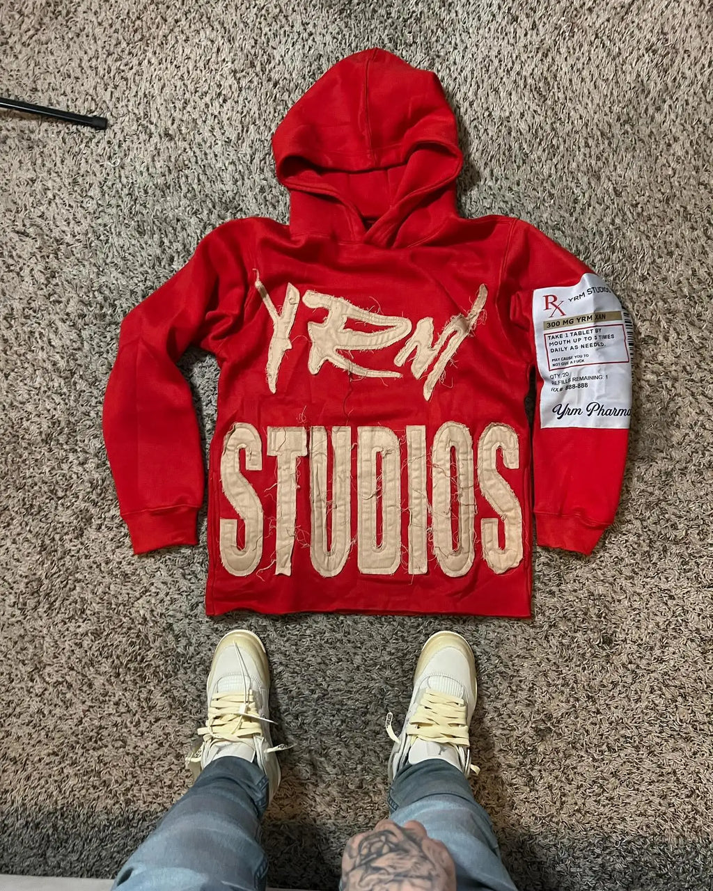 Noxwear Anime Hoodies in red featuring bold white Fenty Studios back print, sleeve patch detail, and oversized streetwear fit.