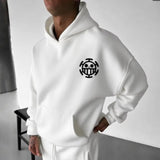 Men’s hooded sweatshirt in white with black chest emblem, paired with matching white pants, featuring cotton fabric for comfort and modern streetwear style.