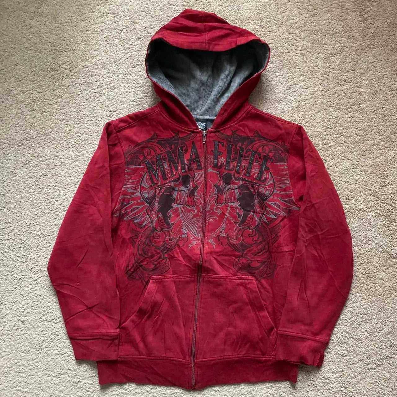 Noxwear Anime Hoodies in red featuring black chest graphic with intricate artistic design, zip‑up front, and oversized streetwear fit.