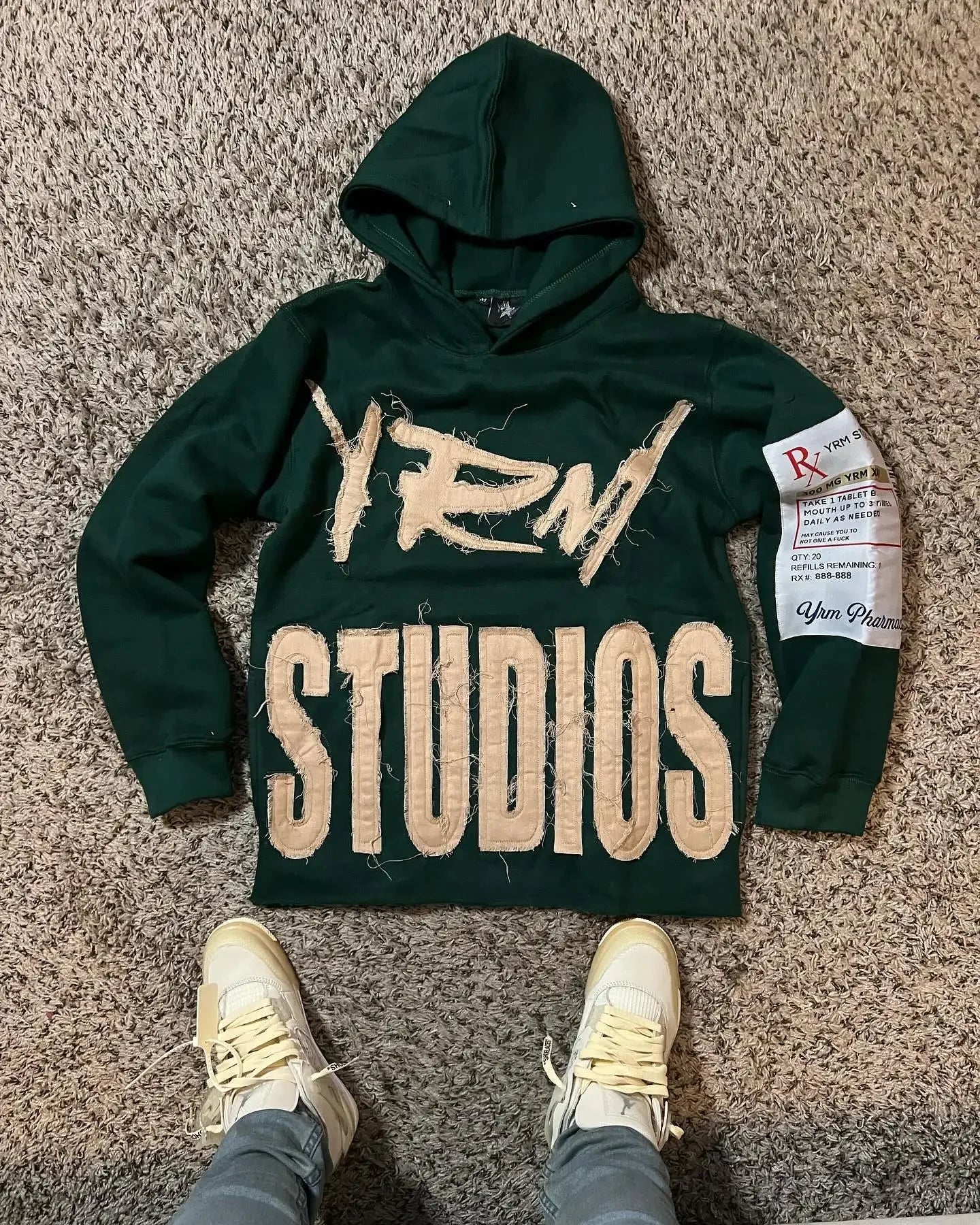 Noxwear Anime Hoodies in dark green featuring bold FEAR STUDIOS back print, sleeve patch detail, and oversized streetwear fit.