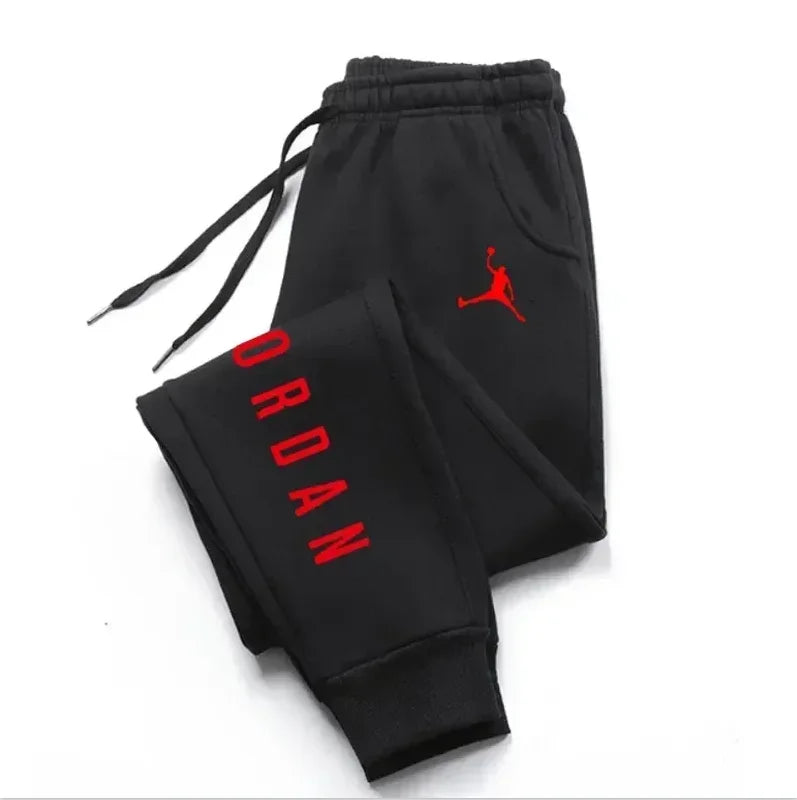 Men’s casual sweatpants in black with red Jordan logo and vertical branding, featuring drawstring waist for comfort and sporty style.